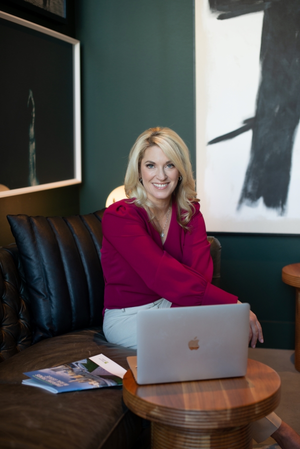 nancy sitting behind laptop smiling